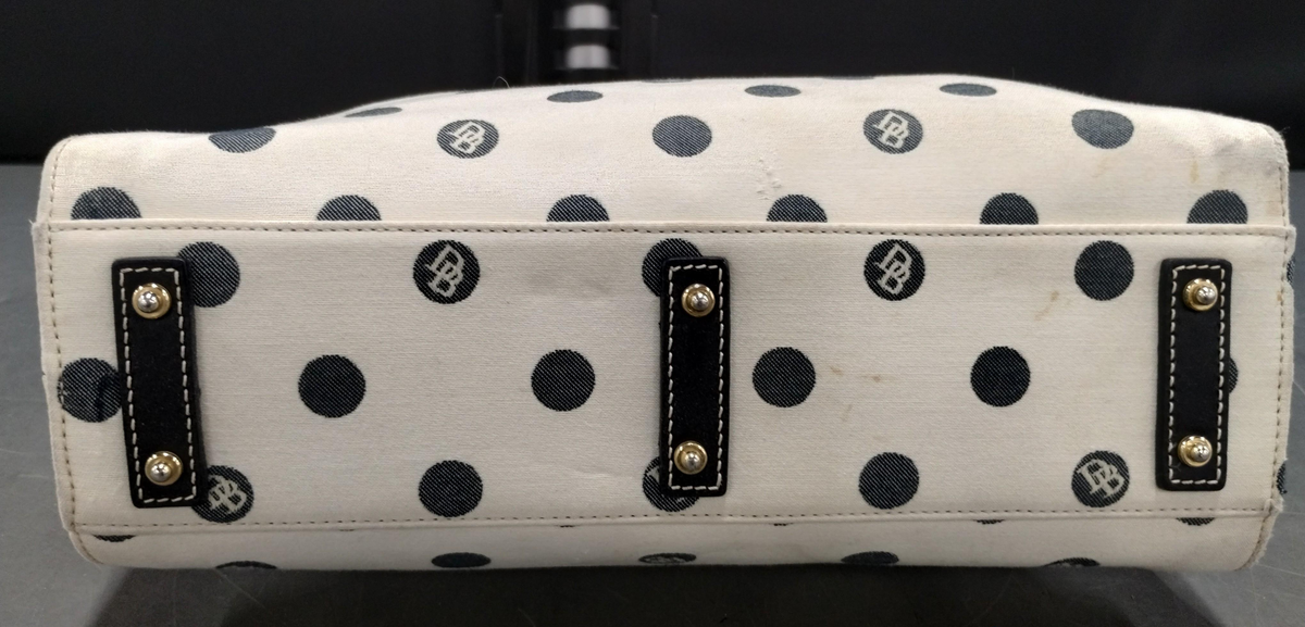 Dooney and Bourke cream canvas tote with black polka dots, black leather straps and blue duck charm, view 5