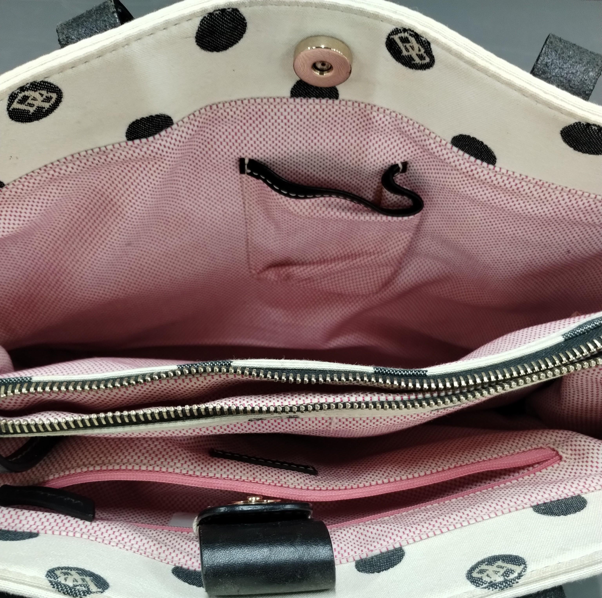 Dooney and Bourke cream canvas tote with black polka dots, black leather straps and blue duck charm, view 6