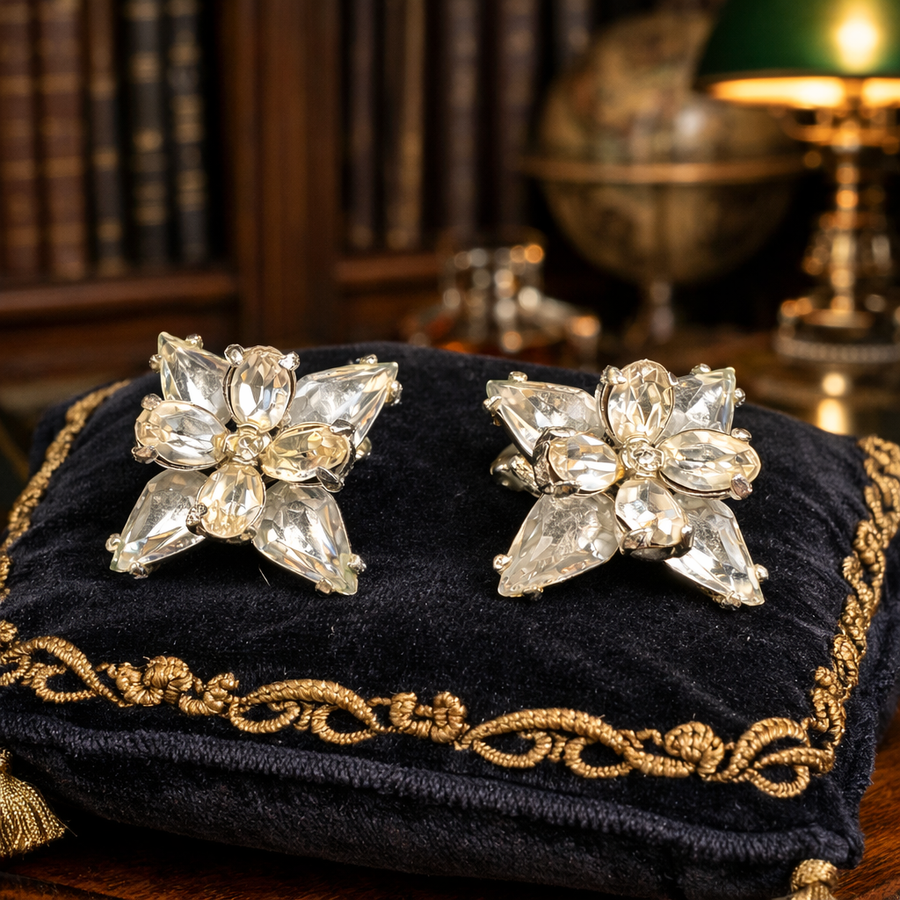 Signed Hollycraft silver-tone floral starburst clip earrings with clear rhinestones