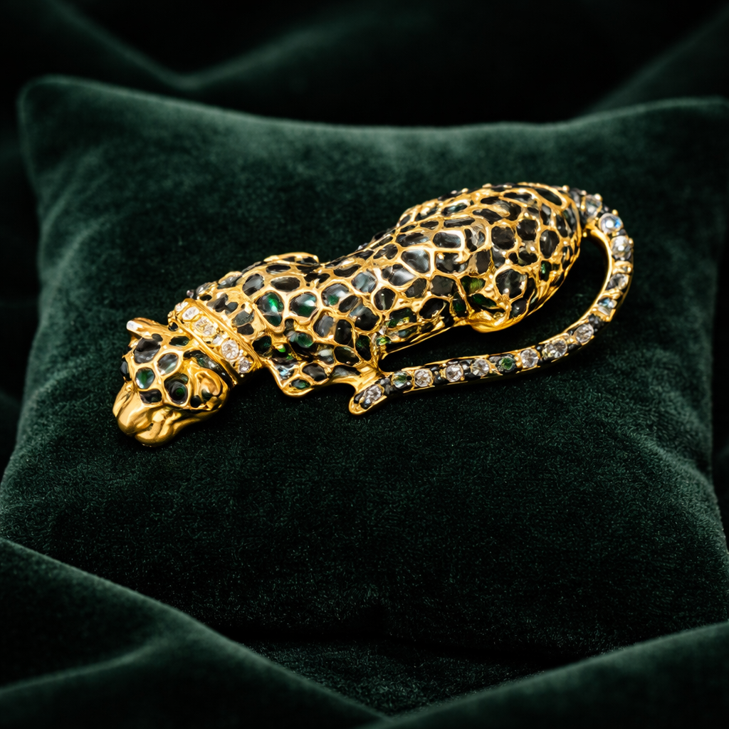 Black enamel reclining panther brooch with gold-tone detail and rhinestone collar