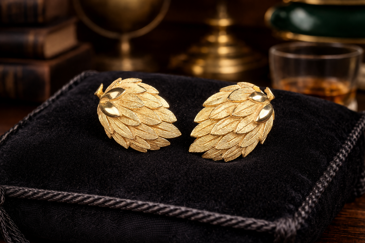 Gold-tone layered leaf clip earrings with rich texture