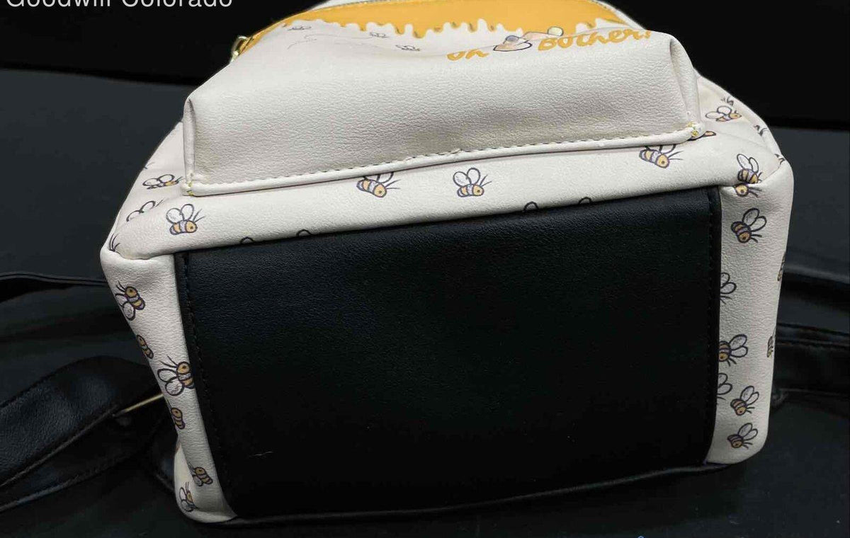 Winnie the Pooh print mini backpack with yellow front pocket and black back panel, view 2