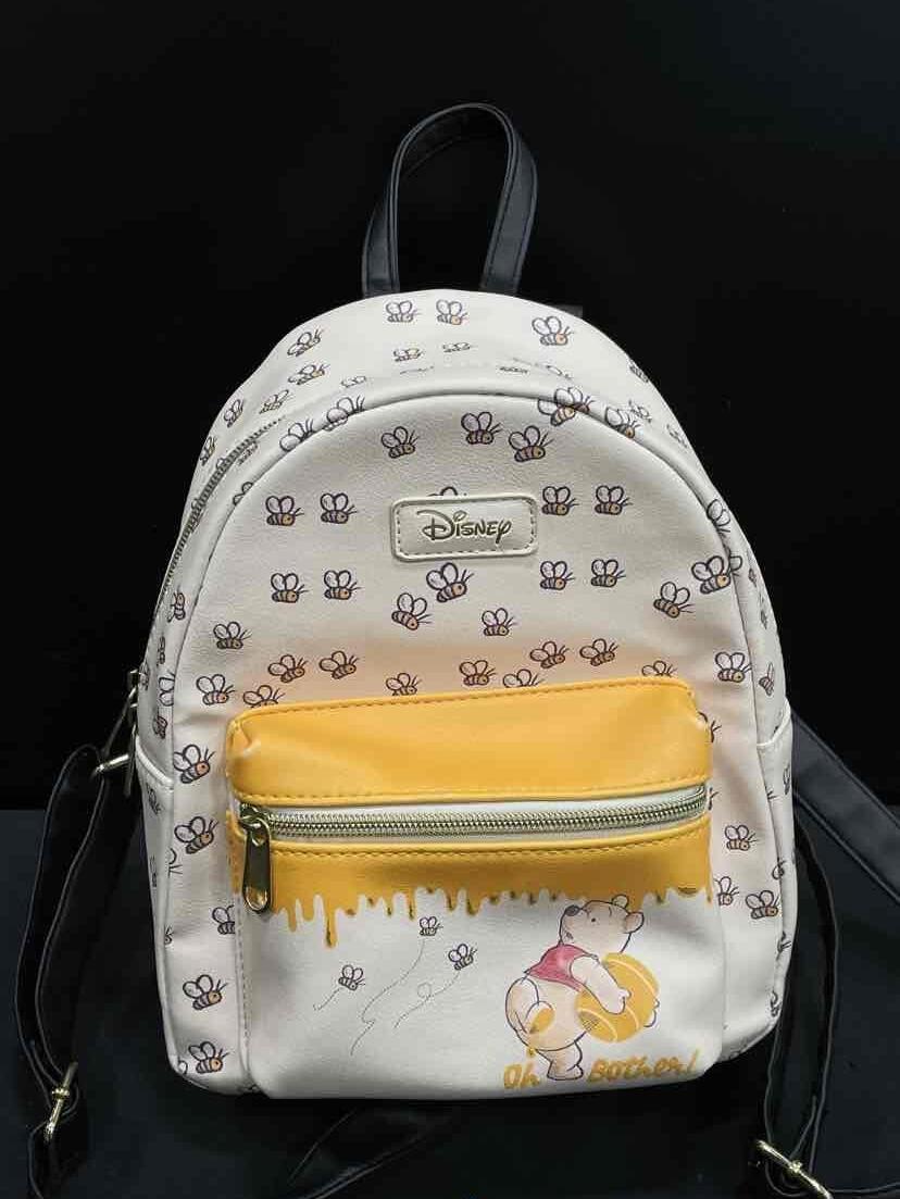 Winnie the Pooh print mini backpack with yellow front pocket and black back panel