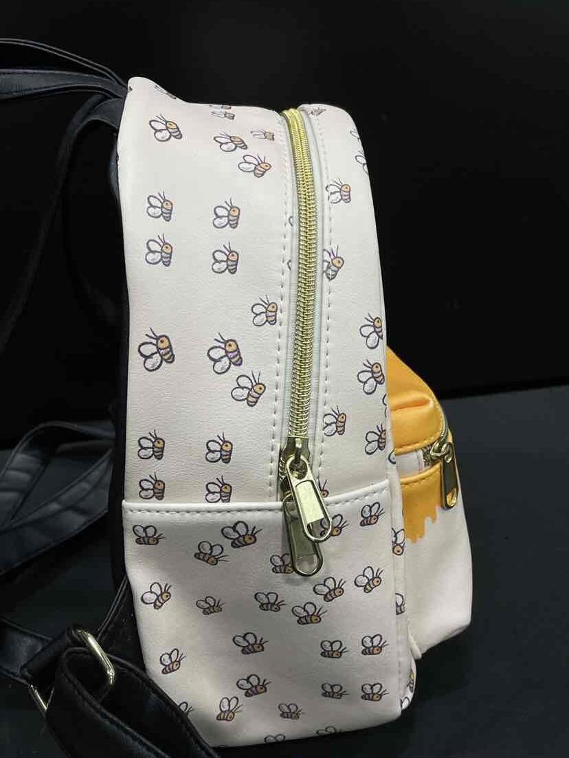 Winnie the Pooh print mini backpack with yellow front pocket and black back panel, view 3