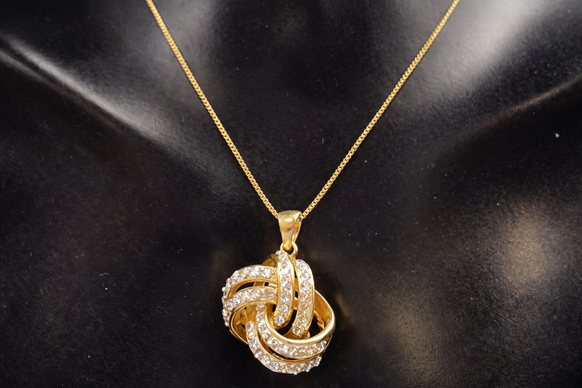 Signed JCM gold-tone interlocking knot pendant necklace with clear rhinestones, view 2