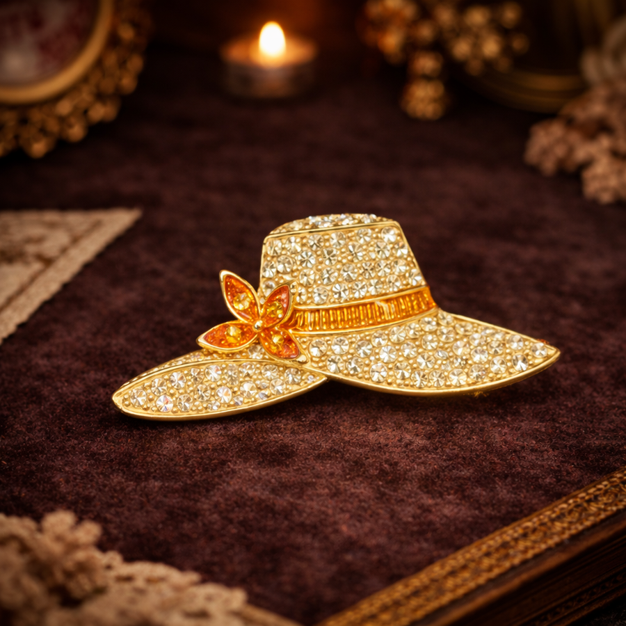 Signed Monet gold-tone sun hat brooch paved with clear rhinestones and amber accent