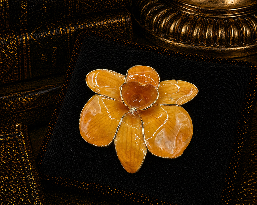 Gold-tone flower brooch with translucent amber-tone veined petals