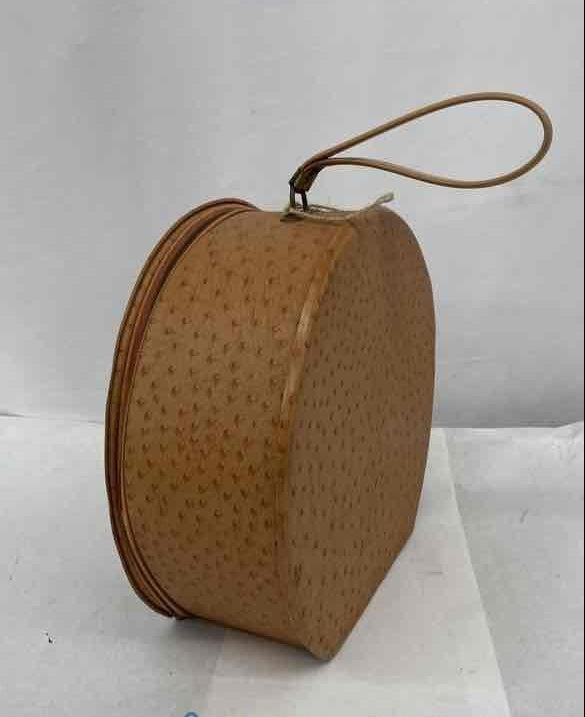 Tan ostrich-textured hard-sided round travel case with short top handle, view 3