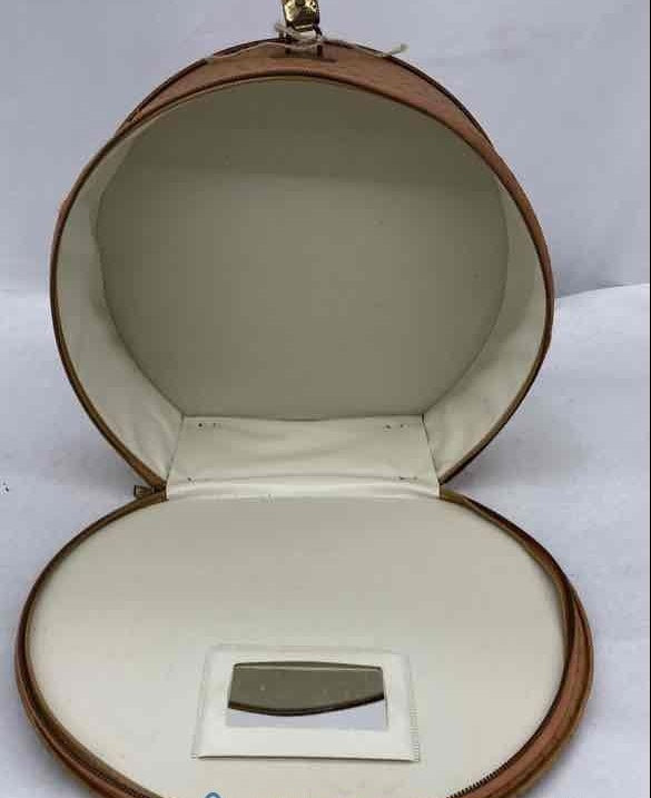 Tan ostrich-textured hard-sided round travel case with short top handle, view 4