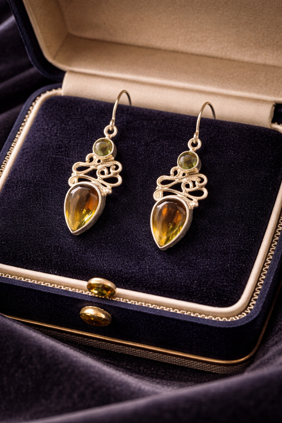 Silver-tone openwork scroll drop earrings with round and teardrop amber-toned stones
