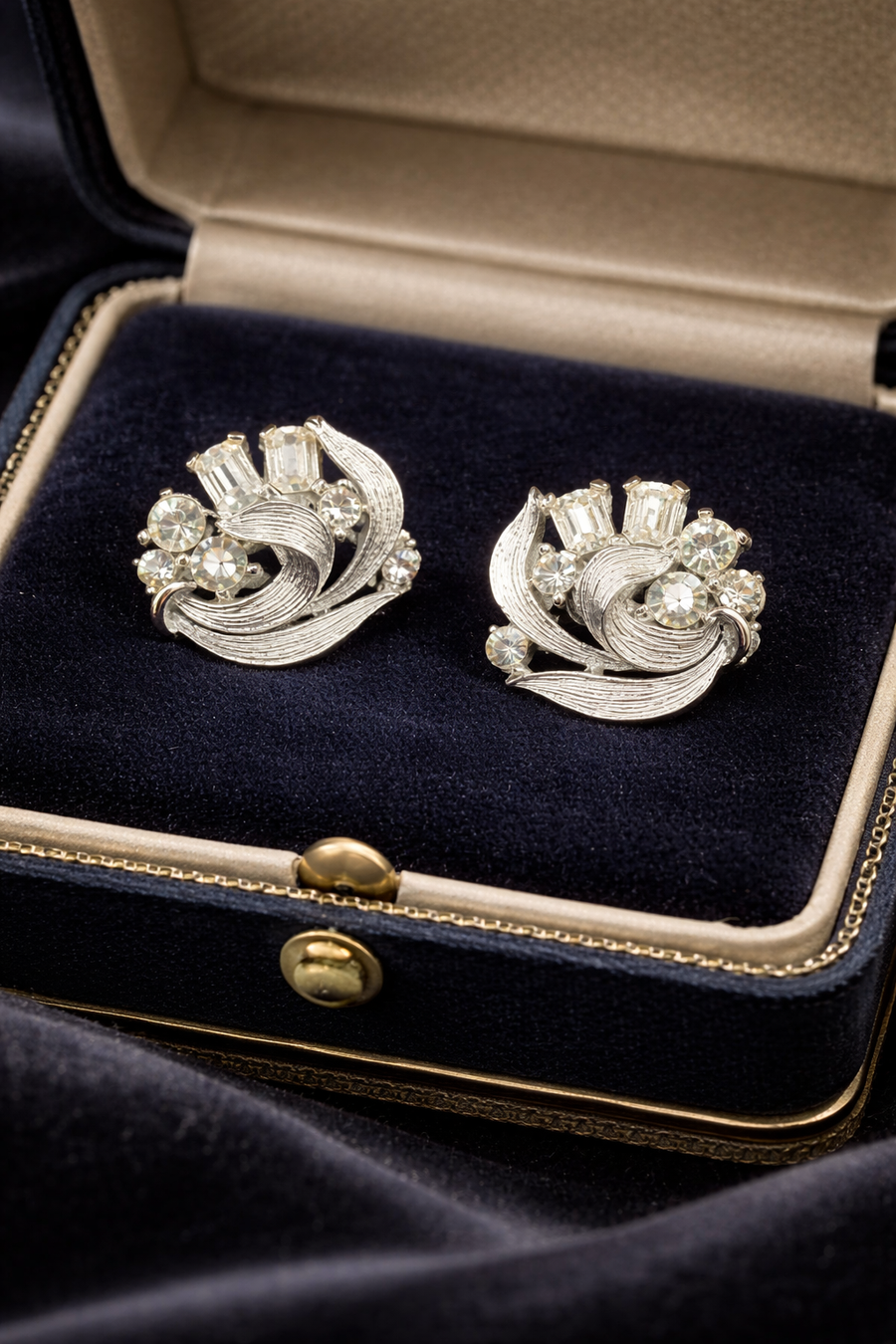 Lisner silver-tone swirl cluster clip earrings with round and baguette rhinestones