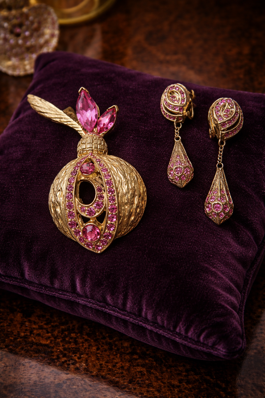 Signed Bellini gold-tone feather brooch and dangle clip earrings with pink rhinestones