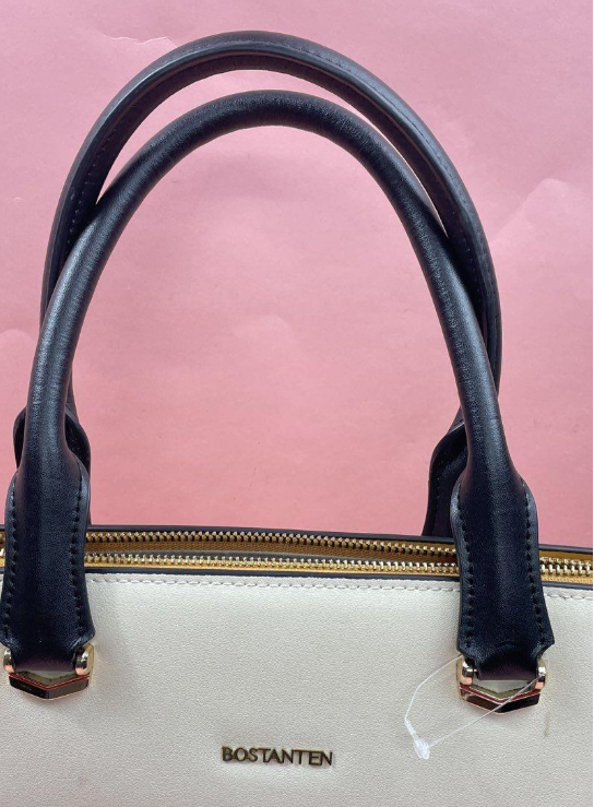 White briefcase-style tote with navy top handles, tan strap accents and zip top, view 3