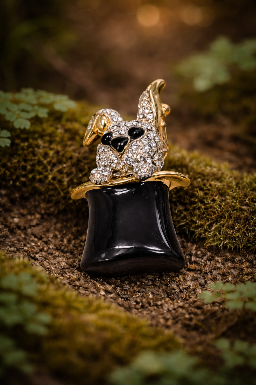 Gold-tone rhinestone bunny brooch emerging from a black top hat