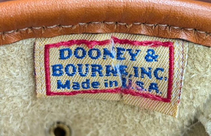 Dooney and Bourke cream pebbled leather saddle crossbody with tan trim and brass-tone duck closure, view 7