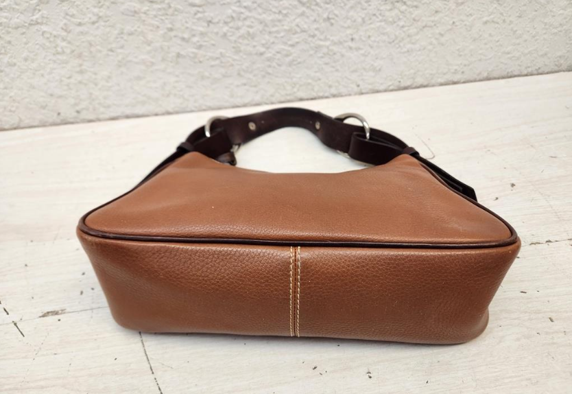 Dooney and Bourke 1975 tan pebbled leather east-west hobo with dark trim and duck charm, view 7