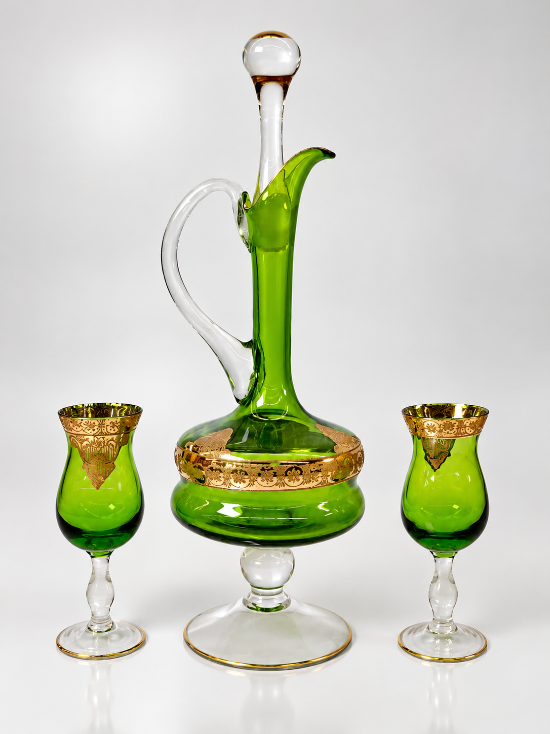 Emerald green glass cordial decanter and six stemmed glasses with ornate gold-tone decoration, view 3