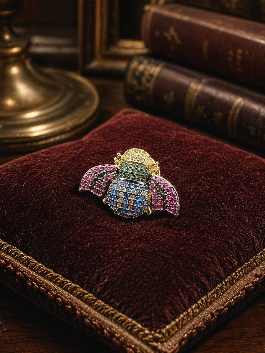 Gold-tone bee brooch with pink, blue, green and clear rhinestones