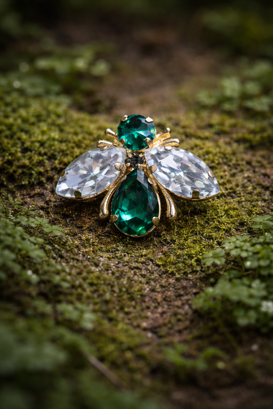 Gold-tone fly brooch with green rhinestone body and clear rhinestone wings