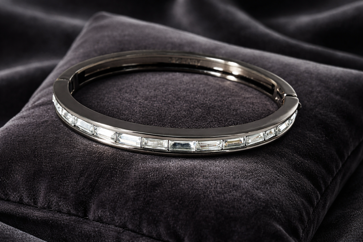 Signed Givenchy gunmetal-tone hinged bangle with channel-set crystal rhinestones