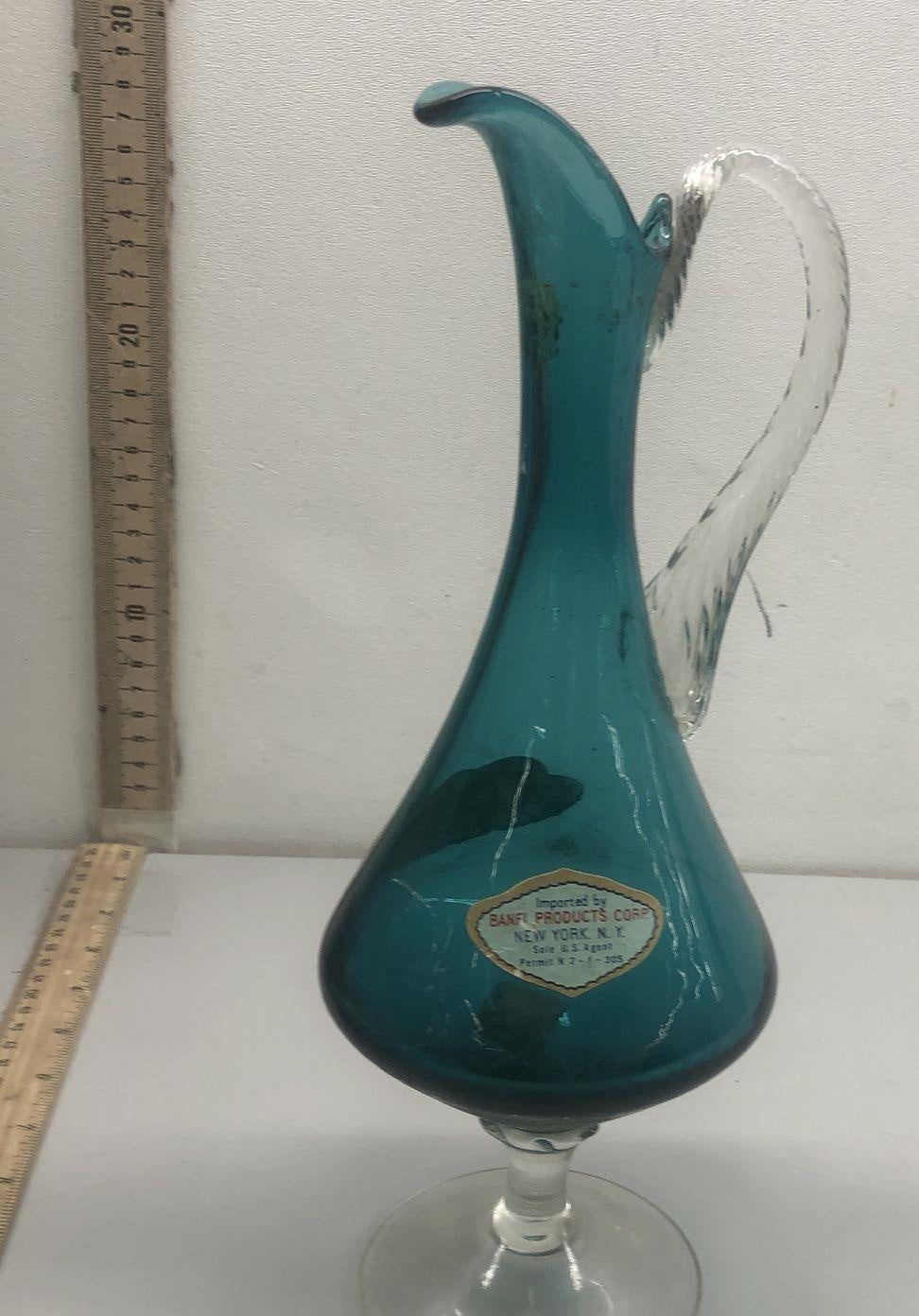 Teal glass ewer with teardrop body, curled lip, clear twisted applied handle and clear foot, view 2