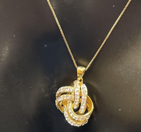 Signed JCM gold-tone interlocking knot pendant necklace with clear rhinestones, view 6