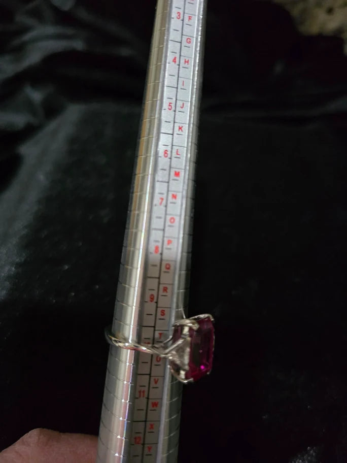 Silver-tone cocktail ring with emerald-cut red center stone and clear trillion side stones, view 7