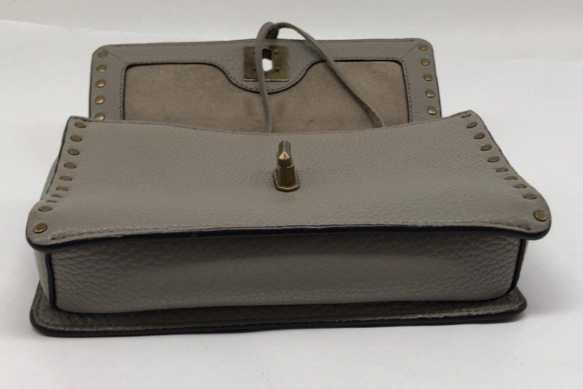 Taupe pebbled leather flap crossbody bag with studded strap, turn-lock and tassel, view 7
