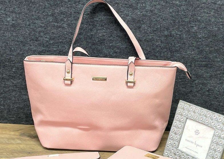 Soft pink structured tote with top handles and small front logo plaque, view 2