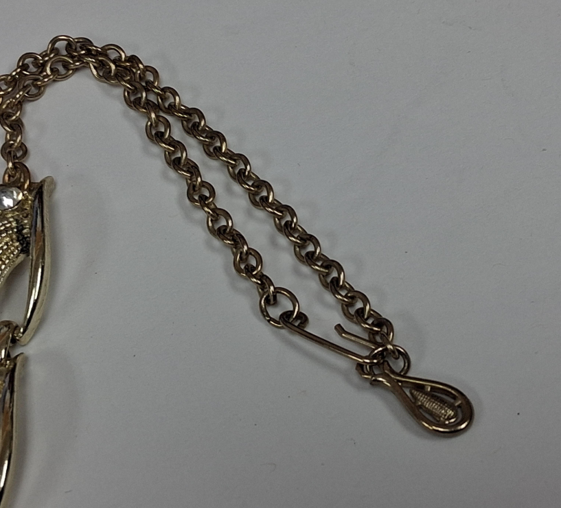 Gold-tone rhinestone statement necklace with leaf and scroll links, view 4