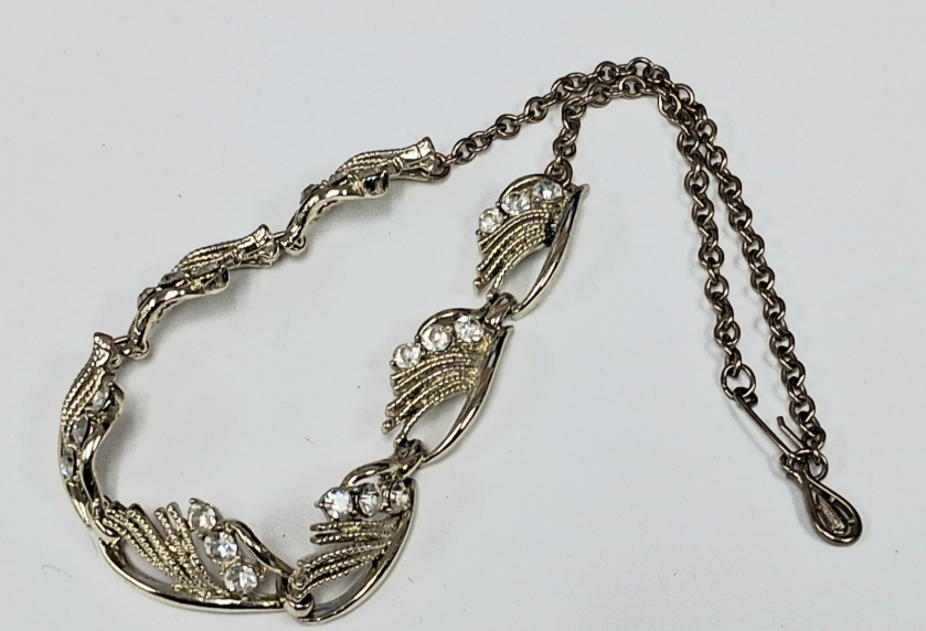 Gold-tone rhinestone statement necklace with leaf and scroll links, view 2