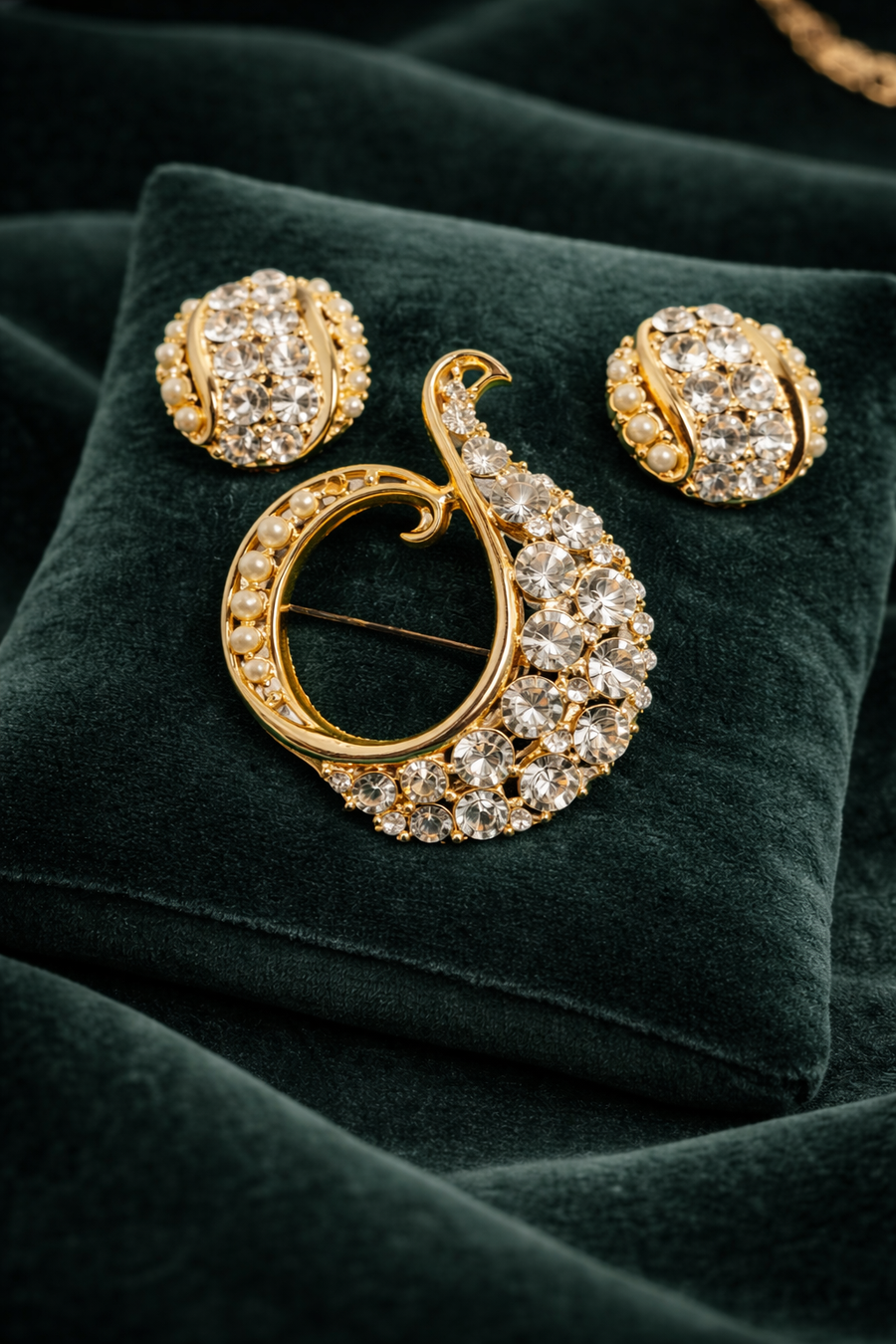 Gold-tone swirl brooch and matching clip earrings with rhinestones and faux pearls