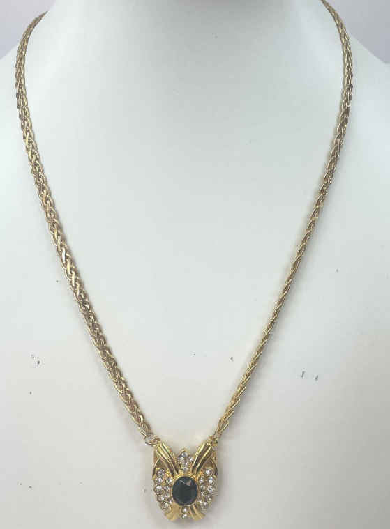 Gold-tone pendant necklace with black cabochon center framed by clear rhinestones, view 2