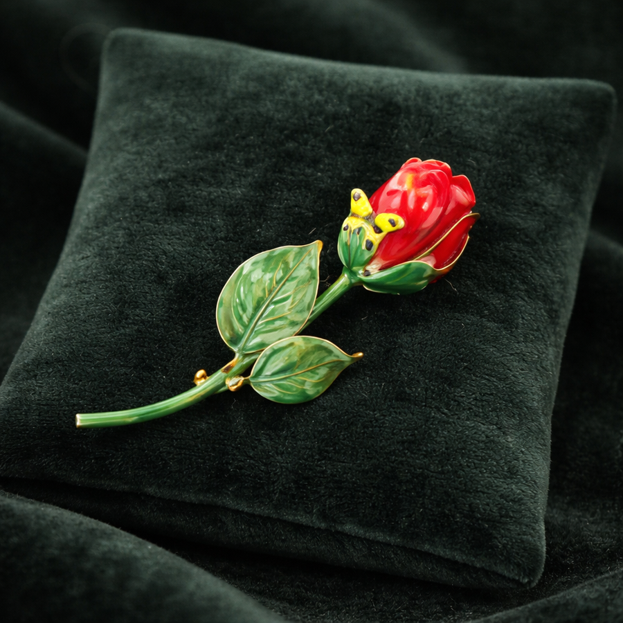 Gold-tone red enamel rose brooch with green stem and butterfly