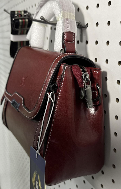 Deep red leather structured satchel with contrast stitching, top handles and crossbody strap, view 4
