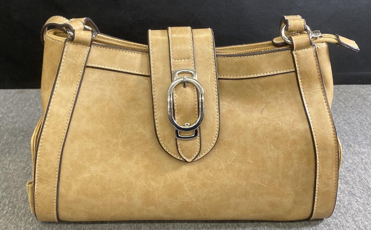 Beige shoulder bag with front buckle and side compartments holding mini pouches, view 2