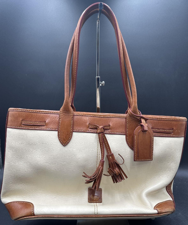 White textured leather tote with tan leather trim, rolled straps and tassels, view 4