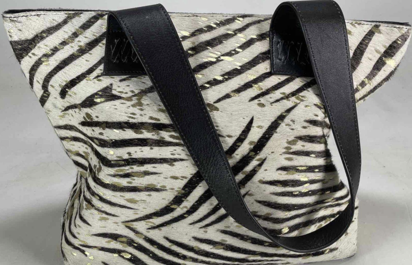 Zebra-striped hair-on-hide tote with black leather handles and trim, view 4