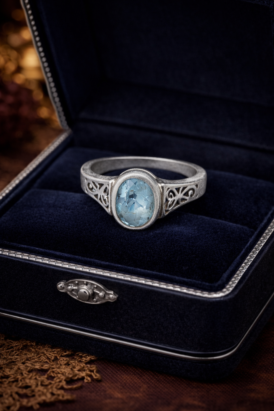 Ring marked 925 with oval blue stone in bezel-style setting and openwork band