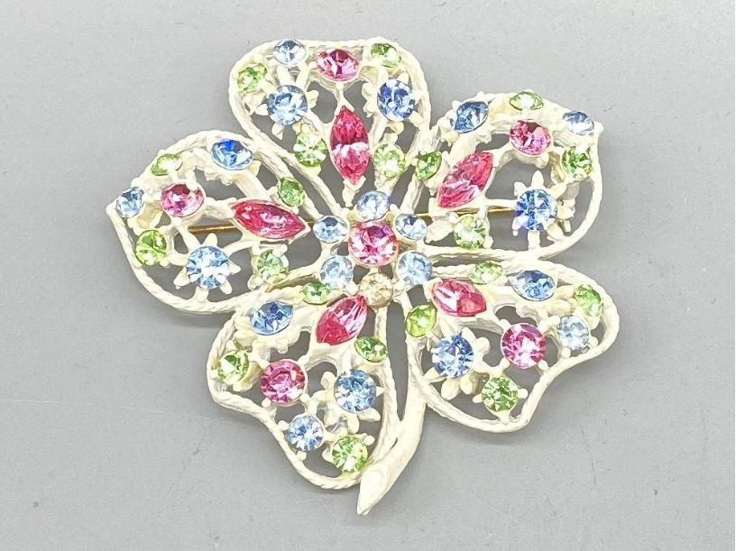 Vintage White Enamel Flower Brooch with Pastel Rhinestones – UV Reactive Green Stones  Description