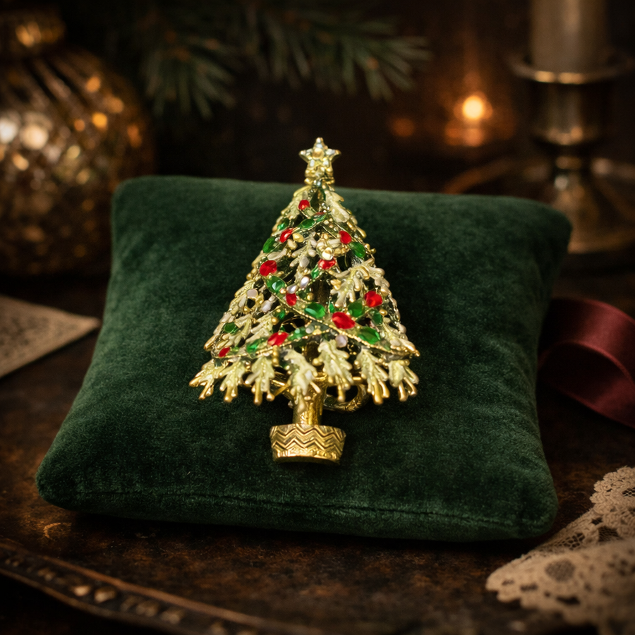 Gold-tone textured Christmas tree brooch with red and green rhinestones, garland and star
