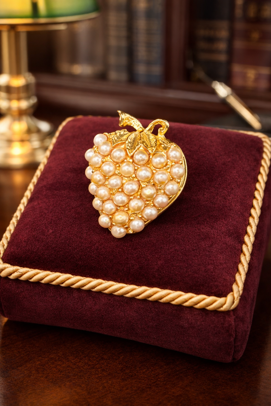Gold-tone strawberry brooch covered in clustered faux pearls with leaf accent