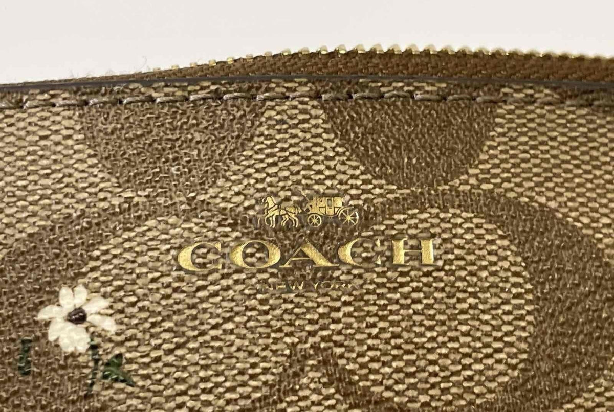 Brown signature jacquard wristlet with small floral print, zip top and wrist strap, view 9