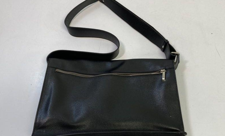 Black leather flap-front messenger bag with adjustable shoulder strap, view 5