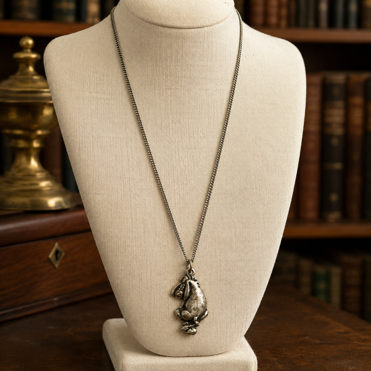 Silver Eeyore character pendant in a seated pose on a fine chain