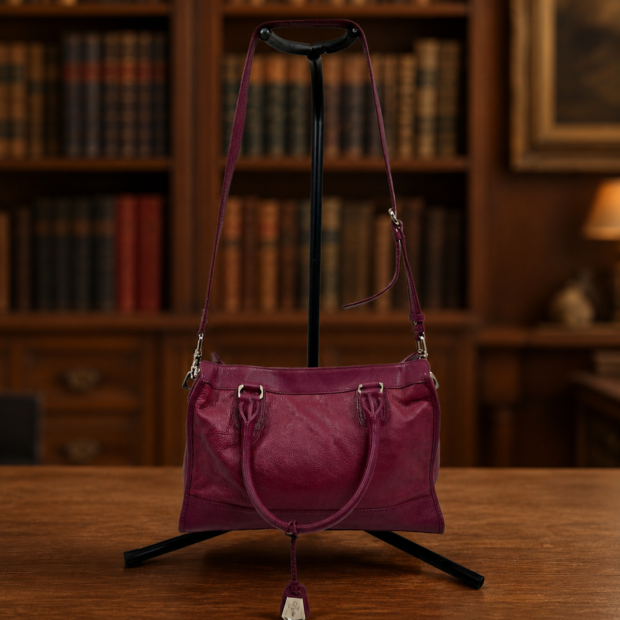 Raspberry leather structured tote with dual top handles and silver-tone plaque
