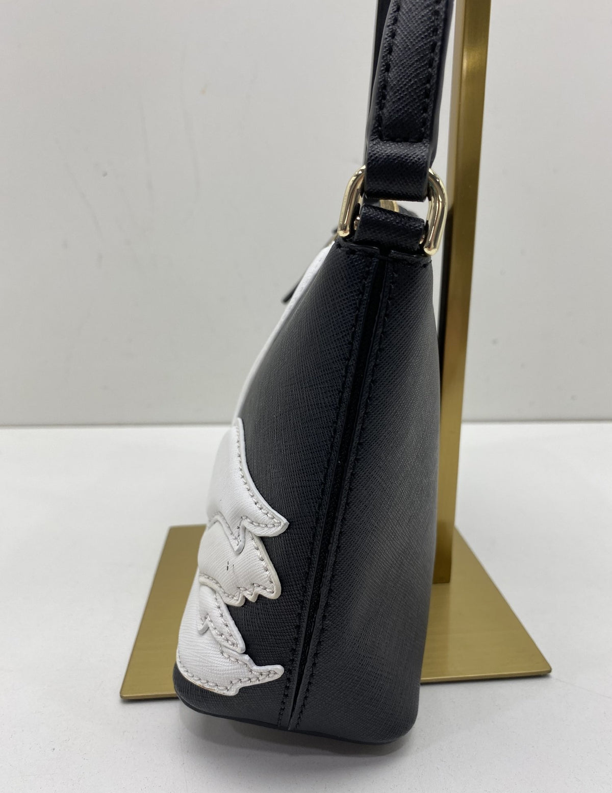 Black structured crossbody bag with white swan appliqué and gold-tone accents, view 4
