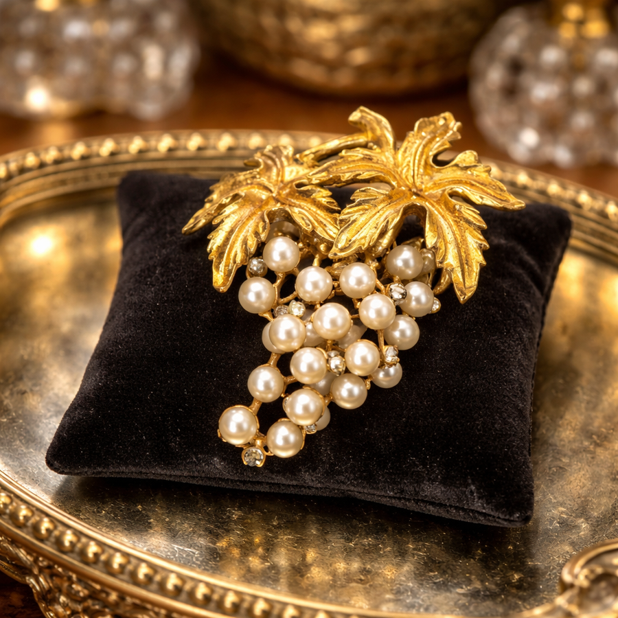 Gold-tone grape cluster brooch with cream faux pearls and textured vine leaves