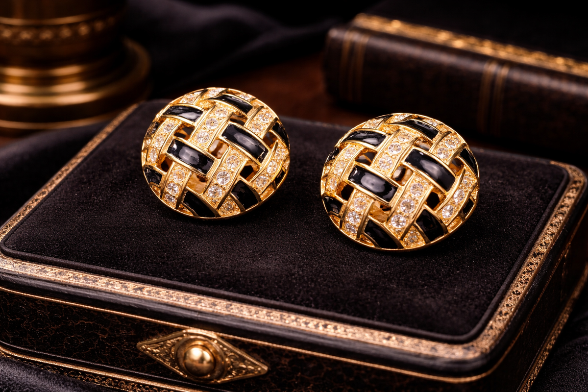 Signed Swarovski gold-tone woven dome clip earrings with clear crystals and black enamel