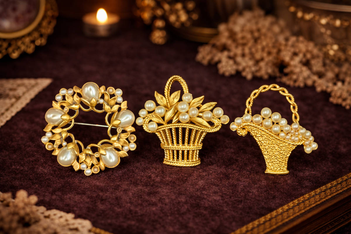 Three gold-tone faux pearl brooches: flower basket, wreath and purse